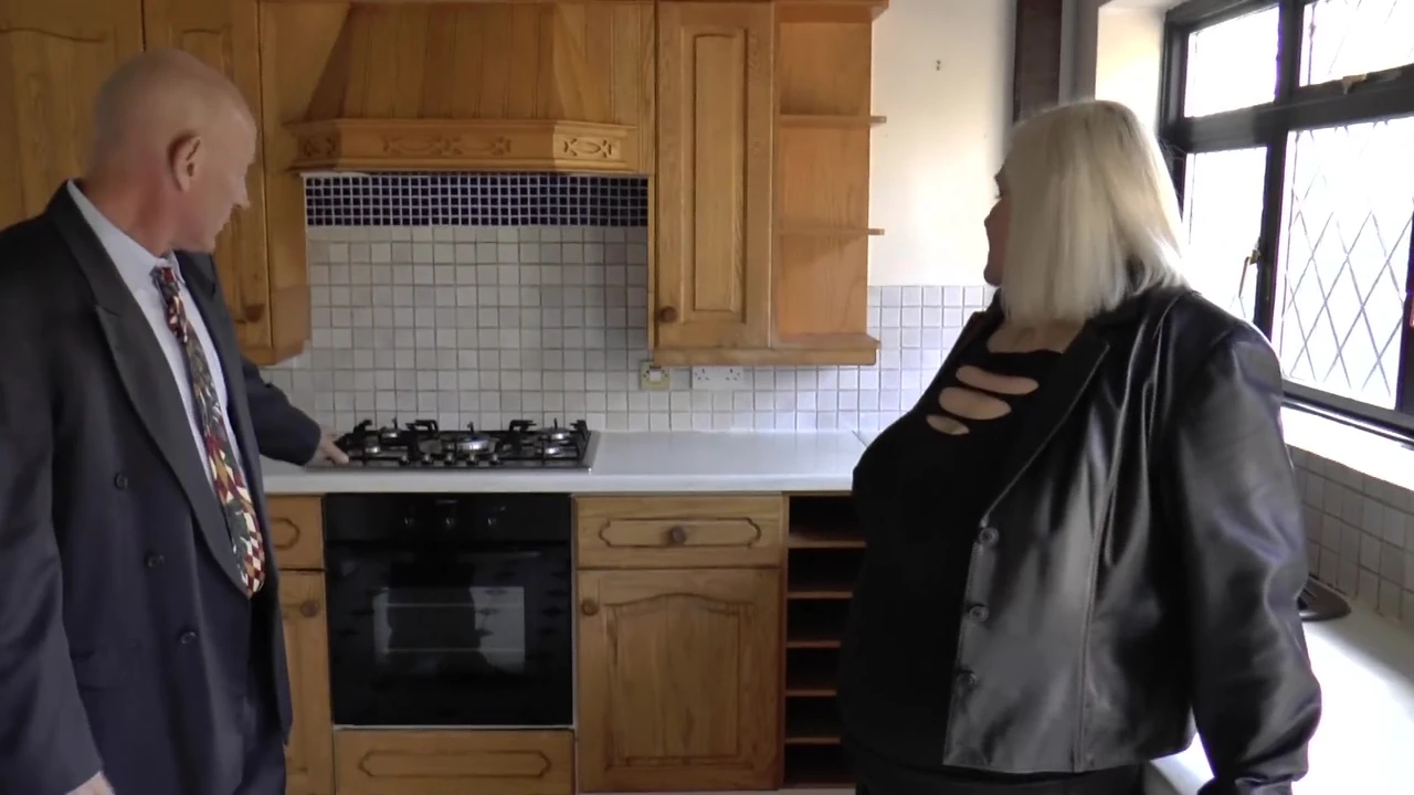 Grandparents getting frisky in the kitchen, no mistaking the sizzle.